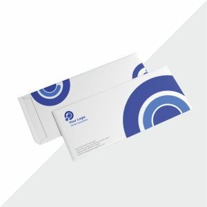White cheque-size envelope placed on a desk, ready for mailing documents or payments